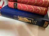 three books stacked on top of each other on a table