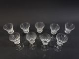 nine empty wine glasses sitting on a black surface