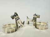 pair of silver dog candlestick holders on a white background