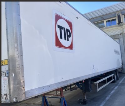 a truck that has a tip sign on the side of it