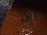 the bottom of a pair of brown leather shoes with a black sole