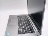 a silver laptop computer sitting on top of a white table