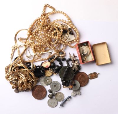a pile of gold and silver jewelry on a white surface