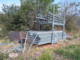 a pile of metal pipes sitting in the middle of a field