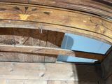 an old wooden bed with a wooden frame and a wooden door