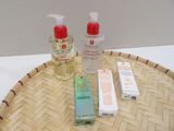 two bottles of lotion and a tube of lotion sitting on a tray