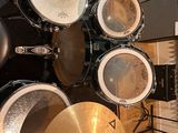 a drum set up in a recording studio with a microphone