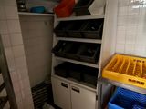 a room with a bunch of boxes and a rack in it