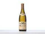 a bottle of white wine sitting on top of a table