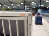 a metal box with a sign on it sitting in a warehouse