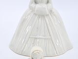 a figurine of a woman in a wedding dress and a dog