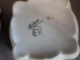 a small white plate with a black writing on it