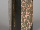 two books sitting on top of each other on top of a table