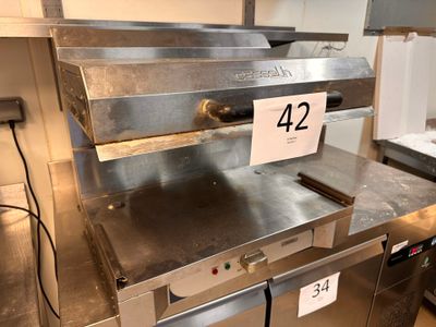 stainless steel counter top with a number 42 on it in a commercial kitchen