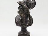 statue of a bust of a man with a hat on top of it