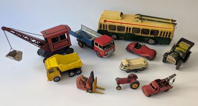 a lot of toy cars and trucks on a white surface