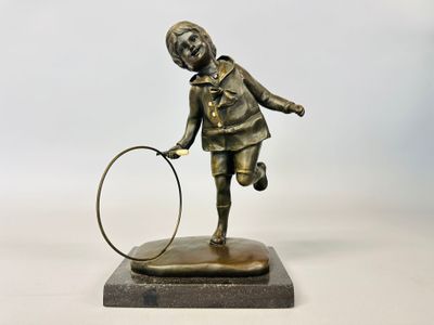 bronze statue of a girl with a hoop on a marble base