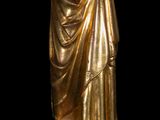 gold statue of a woman holding a glass of wine in her hand