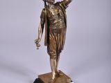 bronze statue of a woman holding a bird on top of a marble base