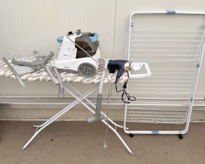 a ironing board and a dryer sitting on top of an ironing board