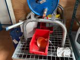 a small machine that has a red bucket in it