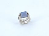 silver ring with a blue stone on a white background