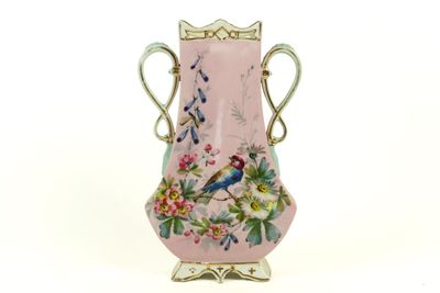 a pink vase with a bird and flowers painted on it