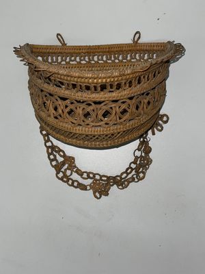 an image of a woven basket with chains hanging on a wall