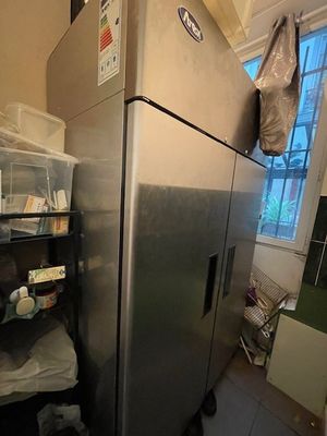 an image of a refrigerator in a kitchen with a lot of stuff on the shelves