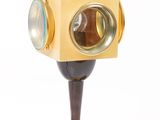 a lamp that is on a stand with a light on top of it
