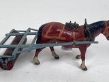 a toy horse pulling a cart with a horse on it