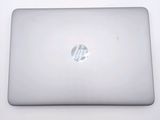 hp laptop computer sitting on a white surface with a logo on the screen