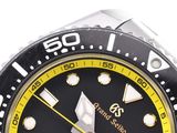 a close up of a watch with a yellow second hand