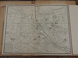 an open book with a map of a city on it sitting on a table