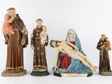 several figurines of jesus, mary, and a man laying on the cross