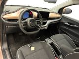the interior of a small car with a steering wheel and dashboard
