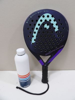a tennis racket and a bottle of water on a table