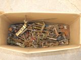 a cardboard box filled with assorted tools on the floor
