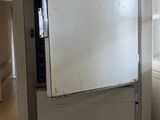 a refrigerator that is sitting in the corner of a room