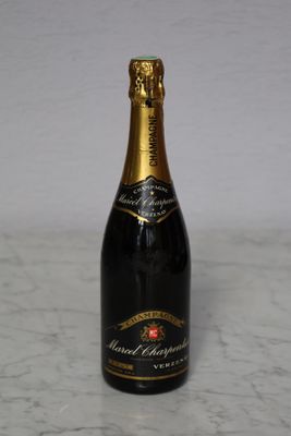 the bottle of champagne is sitting on a marble counter top