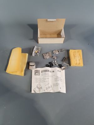 a box with a piece of paper and some other items on a table