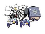 a lot of video game controllers and a game console