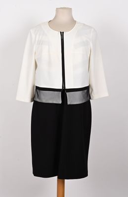 une robe blanche et noire avec une ceinture noire sur un mannequin