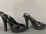 black high heeled shoes with a bow on the toe