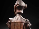 a wooden sculpture of a woman with a hat on her head