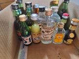 many bottles of alcohol in a box on the table
