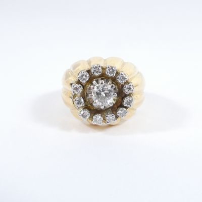 a close up of a diamond ring on a white surface