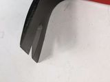 a close up of a red and black wrenet on a white surface