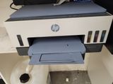 a printer that is sitting on top of a toilet