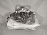 silver leather handbag with a star on the handle